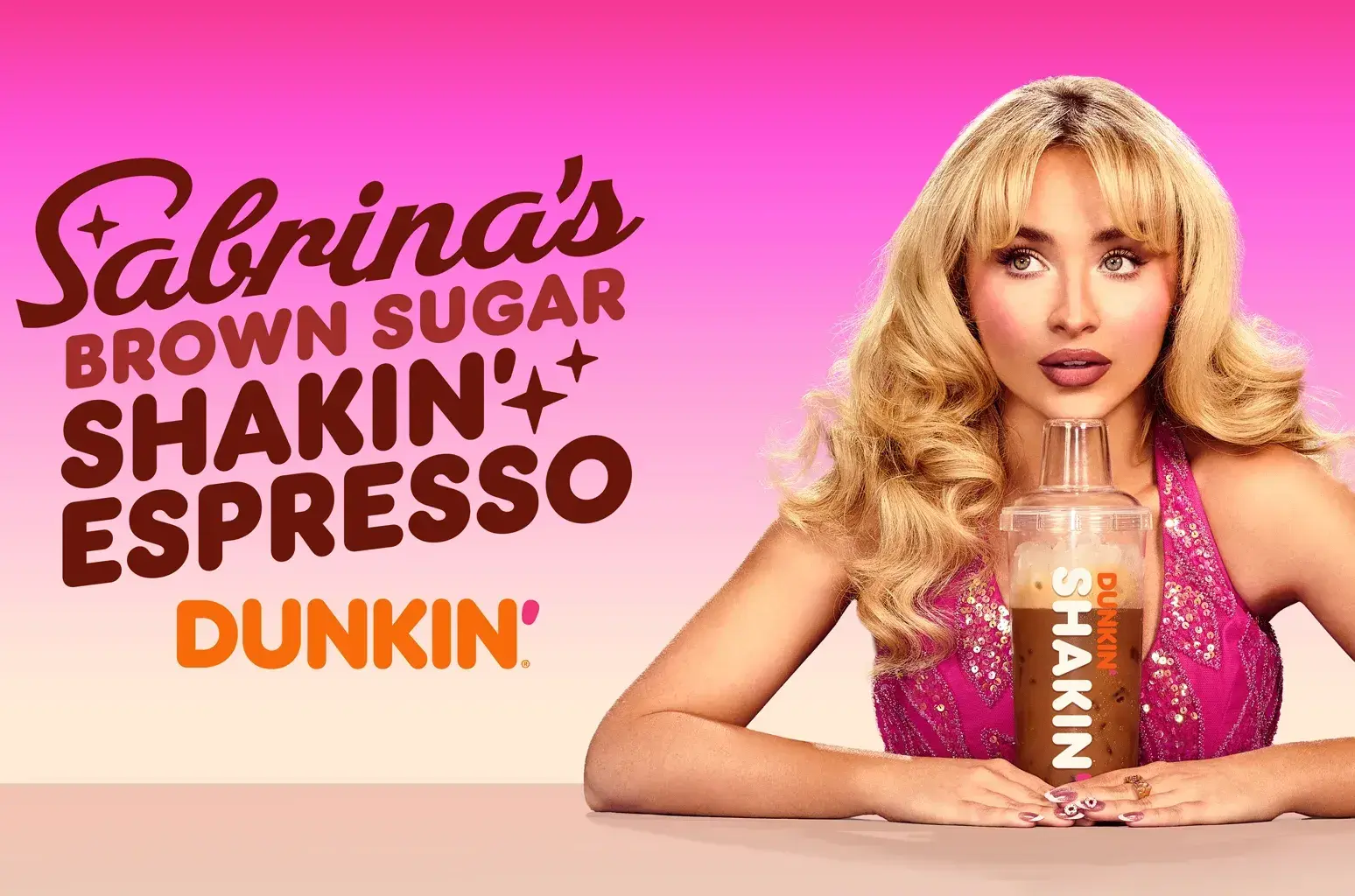 a promotional image of sabrina carpenter with shaken espresso collaboration beverage from dunkin’ donuts